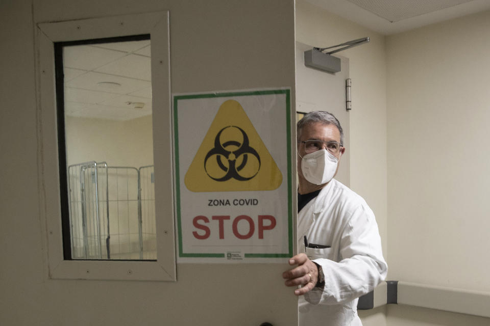 Dr. Gabriele Zanolini, director of the main covid ward at Mellino Mellini hospital in Chiari, northern Italy arrives to enter the ICU, Monday, March 8, 2021. The UK variant surged has filled 90% of hospital beds in Brescia province as Italy crosses the grim threshold of 100,000 pandemic dead and marks the one-year anniversary Wednesday of Italy’s draconian lockdown, the first in the West. (AP Photo/Luca Bruno)