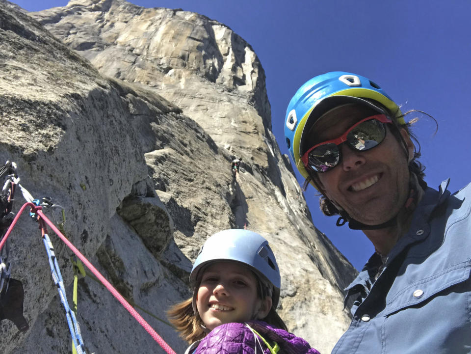 In this June 8, 2019, photo, is Michael Schneiter posing with his daughter, Selah Schneiter, at the beginning of her climb up El Capitan in Yosemite National Park, Calif. A 10-year-old Colorado girl has scaled Yosemite National Park's El Capitan, taking five days to reach the top of the iconic rock formation. Selah Schneiter of Glenwood Springs completed the challenging 3,000-foot (910 meters) climb last week with the help of her father and a family friend. (Michael Schneiter via AP)