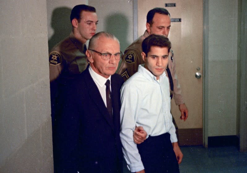 FILE - This June 1968 file photo shows Sirhan Sirhan, right, a suspect of shooting Sen. Robert F. Kennedy, with his attorney Russell E. Parsons in Los Angeles. Associated Press Hollywood reporter Bob Thomas was on a one-night political assignment in June 1968 to cover Kennedy's victory in the California presidential primary when mayhem unfolded before his eyes. (AP Photo/File)