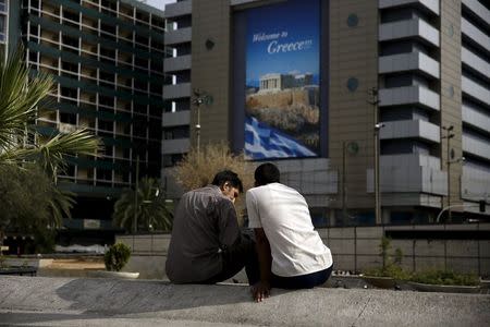 Two men sit at the main Omonia square in Athens, Greece June 27, 2015. REUTERS/Alkis Konstantinidis