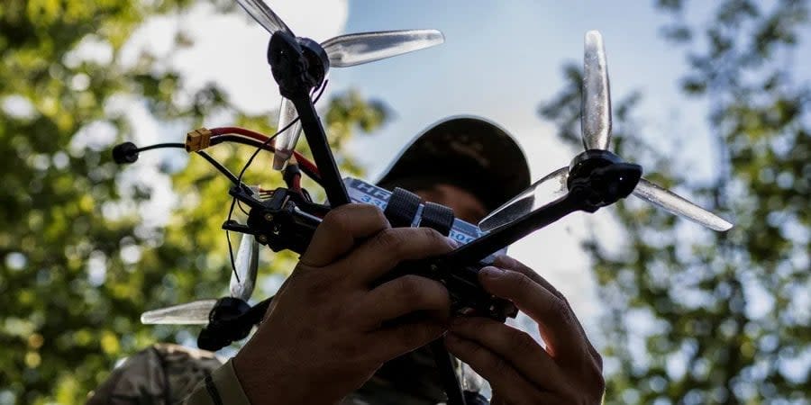 Ukrainian soldier holds an FPV drone in Zaporizhzhya Oblast