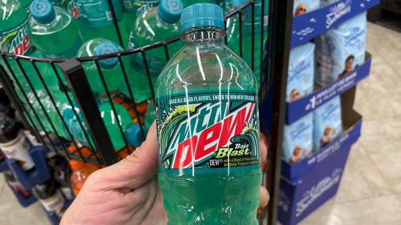 Hand holding Baja Blast bottle