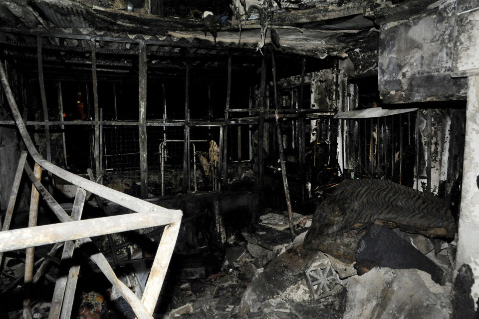 In this photo released on Wednesday, Jan. 23, 2019, by the Syrian official news agency SANA, a burned out apartment of what the Syria's state news agency says seven siblings were killed by a fire that broke out overnight in their apartment, at al-Ammara neighborhood, in the old city of Damascus, Syria. SANA says the cause of the Tuesday night fire in the fourth-floor apartment was not immediately known, adding that it might have been caused by an electric heater. (SANA via AP)