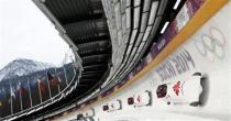 Canada's pilot Lyndon Rush (front) and his teammates speed down the track during a four-man bobsleigh training session at the Sanki Sliding Center in Rosa Khutor, during the Sochi 2014 Winter Olympics near Sochi, February 20, 2014. REUTERS/Fabrizio Bensch