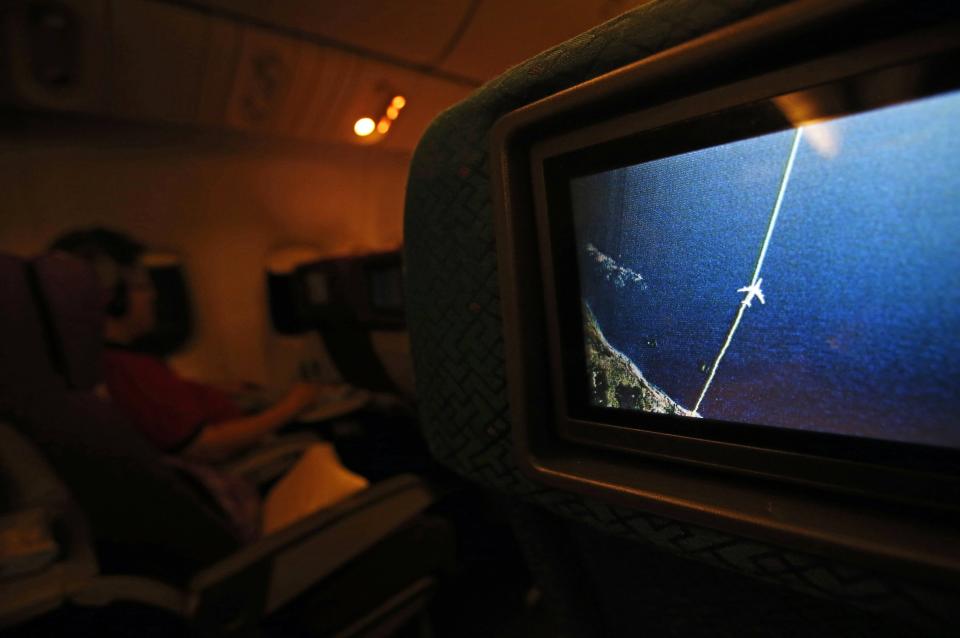 A screen shows the flight path of the Malaysia Airlines Boeing 777-200ER flight MH318 as it cruises towards Beijing over the South China Sea