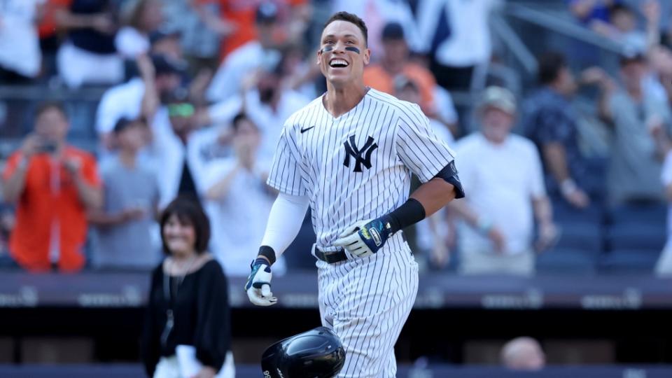 Jun 26, 2022; Bronx, New York, USA; New York Yankees center fielder Aaron Judge (99) tosses his helmet as he comes home after hitting a game winning walk off three run home run against the Houston Astros during the tenth inning at Yankee Stadium.