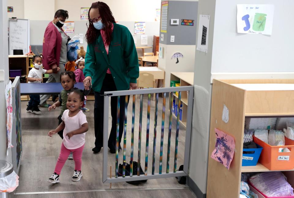 Toddlers excitedly run in for lunch as Yolanda Williams, owner of Dee's Little Angels Child Care Center in Detroit helps lead them into the room on Thursday, April 20, 2023.  Child care providers have been frustrated by the delay in DHHS notifications when children who receive subsidies through the state's child care subsidy program get their hours reduced or canceled.