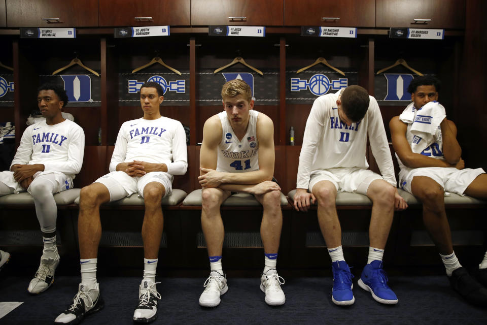 Duke guard Mike Buckmire, from left, forward Justin Robinson, forward Jack White, center Antonio Vrankovic and center Marques Bolden sit in the Duke locker room after an NCAA men's East Regional final college basketball game against Michigan State, Sunday, March 31, 2019, in Washington. Michigan State won 68-67. (AP Photo/Patrick Semansky)