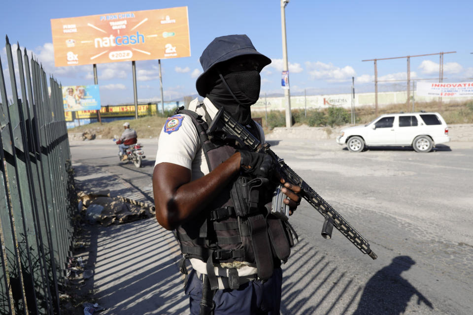 A National Police officer patrols an intersection in Port-au-Prince, Haiti, Friday, Jan. 26, 2024. A court in Kenya on Friday blocked the deployment of a U.N.-backed police force to help fight gangs in the troubled Caribbean country. (AP Photo/Odelyn Joseph)