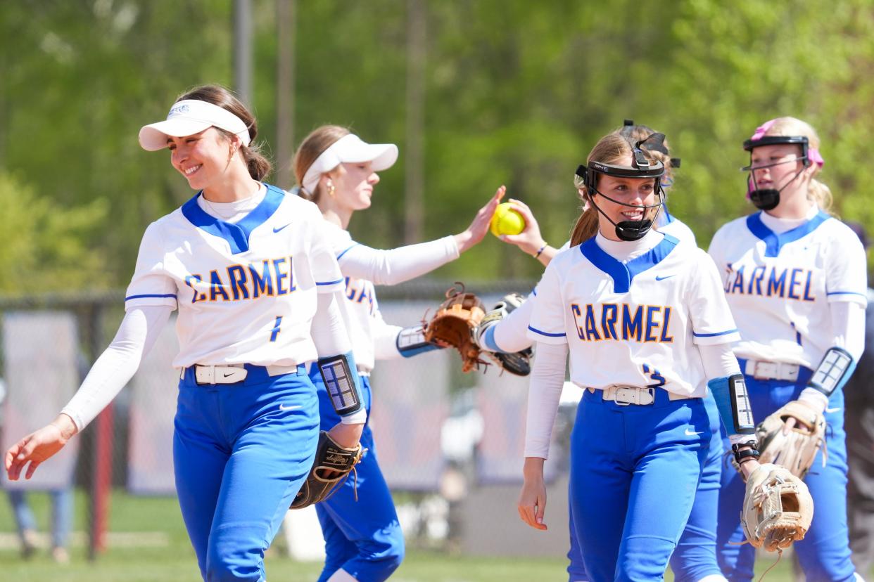The Carmel Greyhounds celebrate making an out against the Roncalli Royals during the Carmel Softball Invitational on Saturday, April 20, 2024, at the Cherry Tree Softball Complex in Carmel, Indiana.