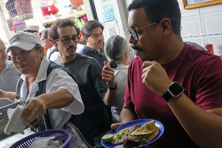 Customers are served tacos at El Califa de Leon in Mexico City on May 15, 2024 (Silvana FLORES)