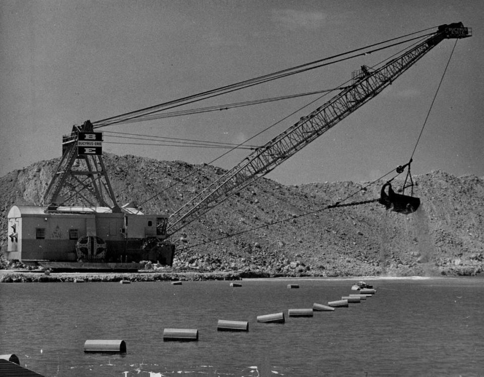 A gigantic bucketed drag line picks up about 20 yards of native oolite at a time in rock pit near the Hialeah Gardens exit of new turnpike extension in 1974.