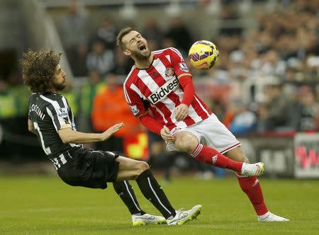 Newcastle United's Fabricio Coloccini (L) challenges Sunderland's Steven Fletcher during their English Premier League soccer match at St James' Park in Newcastle, northern England December 21, 2014. REUTERS/Andrew Yates