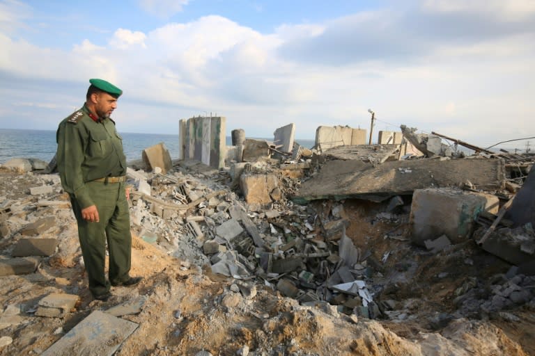 A Palestinian security man surveys the destruction from an Israeli air strike on the southern Gaza Strip town of Rafah on October 17, 2018