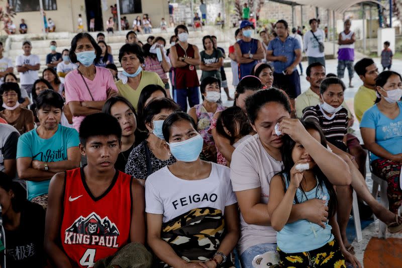 Residents displaced by Taal Volcano's eruption attend a Catholic mass in an evacuation center