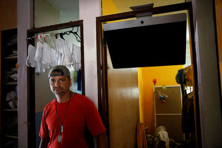 Gary Rosario poses for a photo at his house after the area was hit by Hurricane Maria in Yauco, Puerto Rico, September 25, 2017. REUTERS/Carlos Garcia Rawlins