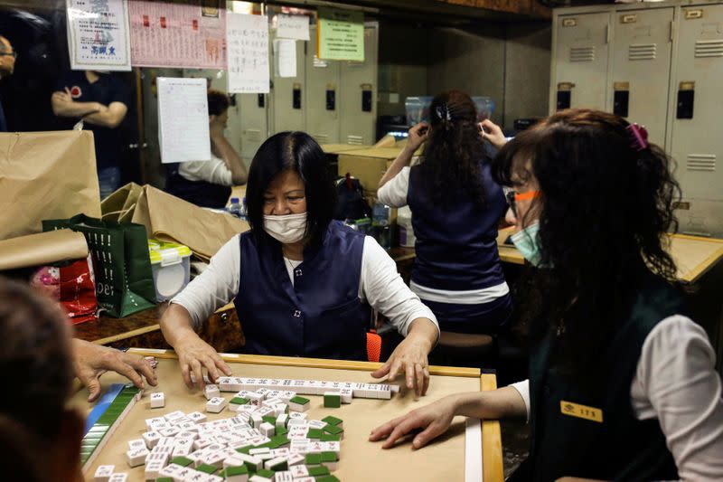 Staff of a massage parlour, without customers to attend to, play mahjong in their break room as Taiwan's entry restrictions to foreign travellers due to the coronavirus disease (COVID-19) continues to affect the tourism reliant massage business in Taipei
