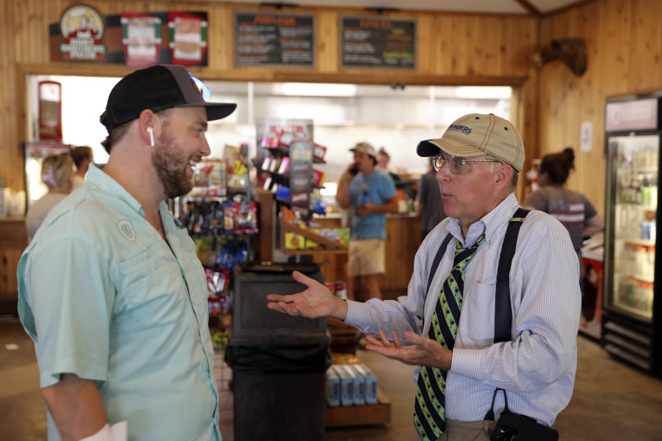 South Carolina state Sen. Mike Fanning, D-Great Falls, right, talks to a constituent as he travels across his district, Saturday, Aug. 5, 2023, in Winnsboro, S.C. In an increasingly Republican state, Fanning hopes the personal touch can help him keep his seat. (AP Photo/Jeffrey Collins)