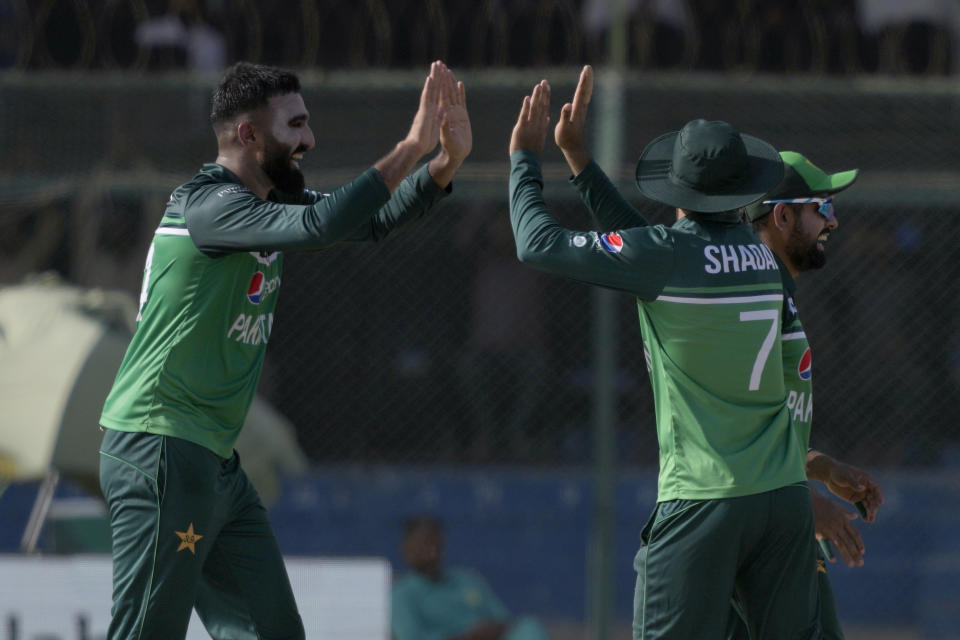 Pakistan's Usama Mir, left, celebrates with teammates after taking the wicket of New Zealand's Henry Nicholls during the fifth one-day international cricket match between New Zealand and Pakistan, in Karachi, Pakistan, Sunday, May 7, 2023. (AP Photo/Fareed Khan)