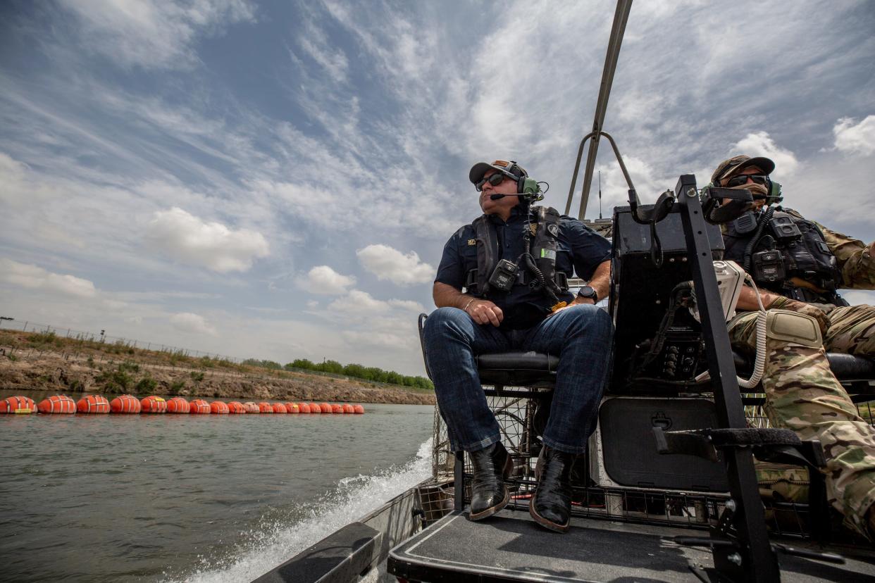 Texas Border Czar Mike Banks navigates in the Rio Grande pass buoys on the Rio Grande in Eagle Pass, Texas during his visit to Shelby Park in Eagle Pass, Texas on April 16, 2024.