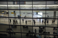 FILE In this file photo dated Tuesday, Jan. 26, 2021, people in the arrivals area at Heathrow Airport in London, during England's coronavirus lockdown. The return of international travel is key to economic recovery across Europe, particularly for countries that rely more heavily on tourism, according to figures released Thursday June 24, 2021, from the World Travel and Tourism Council.(AP Photo/Matt Dunham, FILE)