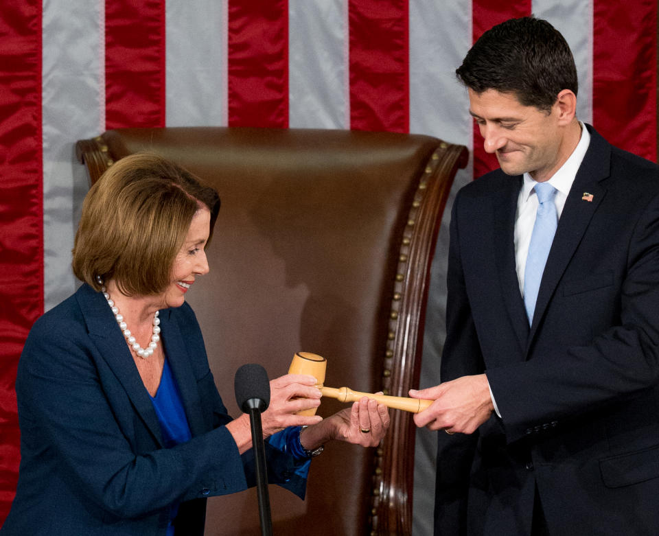 Ryan, newly elected as House speaker, receives the speaker’s gavel from House Minority Leader Nancy Pelosi, D-Calif., Oct. 29, 2015. (Photo: Andrew Harnik/AP)