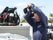 <p>Alan Schwandt, an air conditioning repairman, removes his hat and glasses to wipe sweat from his face while examining a rooftop unit in Scottsdale, Ariz., June 19, 2017. (Angie Wang/AP) </p>