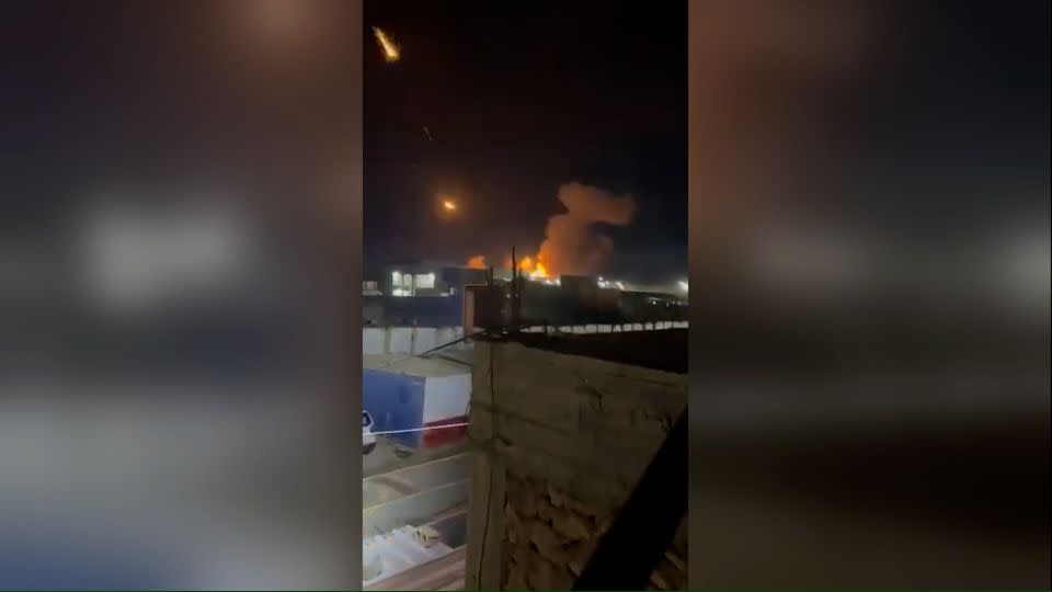 A screengrab from a video, geolocated by CNN to the town of Qaim, Iraq, shows the aftermath of US military strikes in the area, according to the Iraqi Military. An apparent weapons depot was hit, and a number of flares from projectiles were seeing rocketing into the sky. - Obtained by CNN