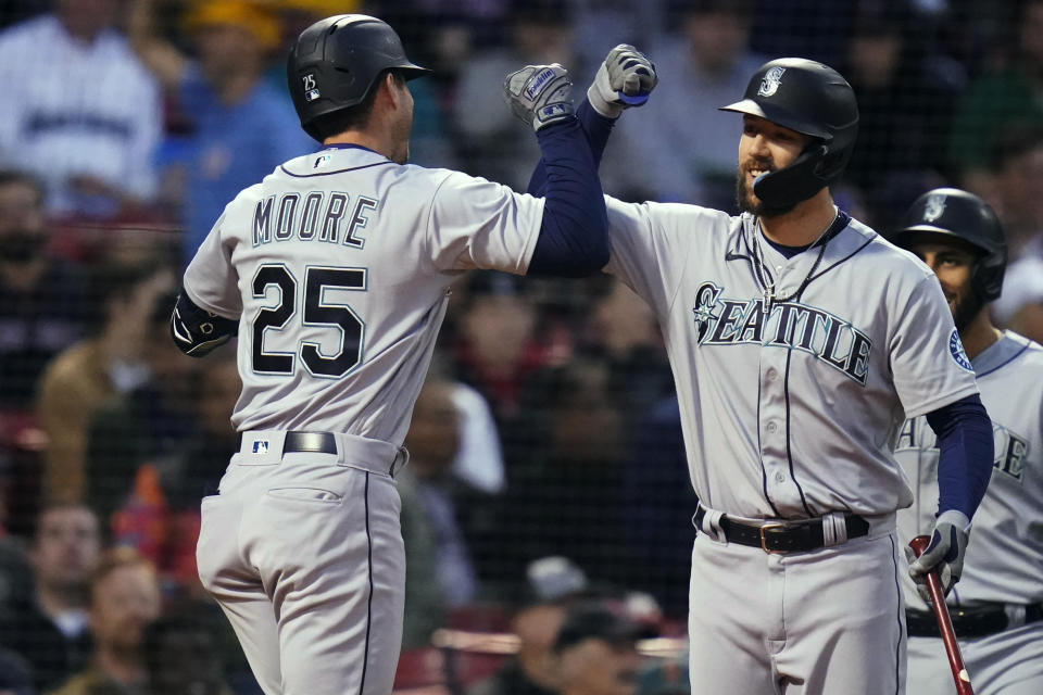 Seattle Mariners' Dylan Moore (25) is congratulated by Steven Souza Jr. after his three-run home run against the Boston Red Sox during the second inning of a baseball game at Fenway Park, Thursday, May 19, 2022, in Boston. (AP Photo/Charles Krupa)