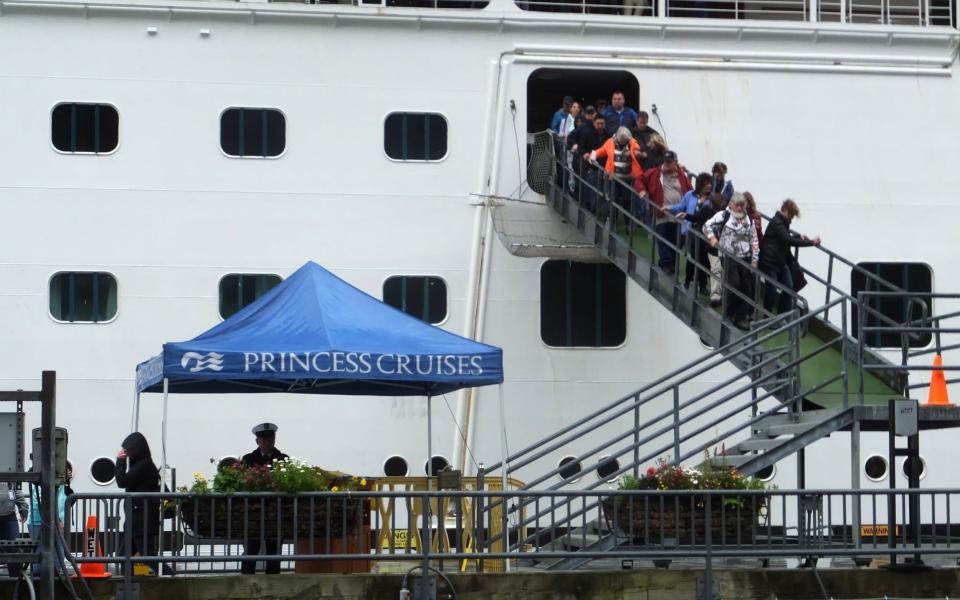 Passengers of the Emerald Princess cruise ship disembark on Wednesday - Credit: AP