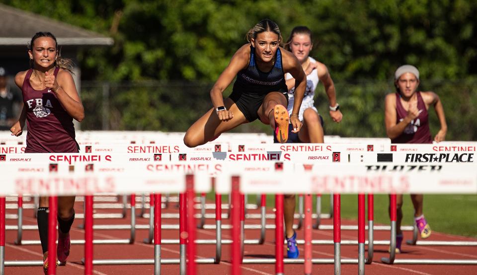 Joslyne De La Nuez from Canterbury School wins the girls 100 hurdles during the Private 8 track and field meet at Evangelical School on Friday, April 19, 2024.