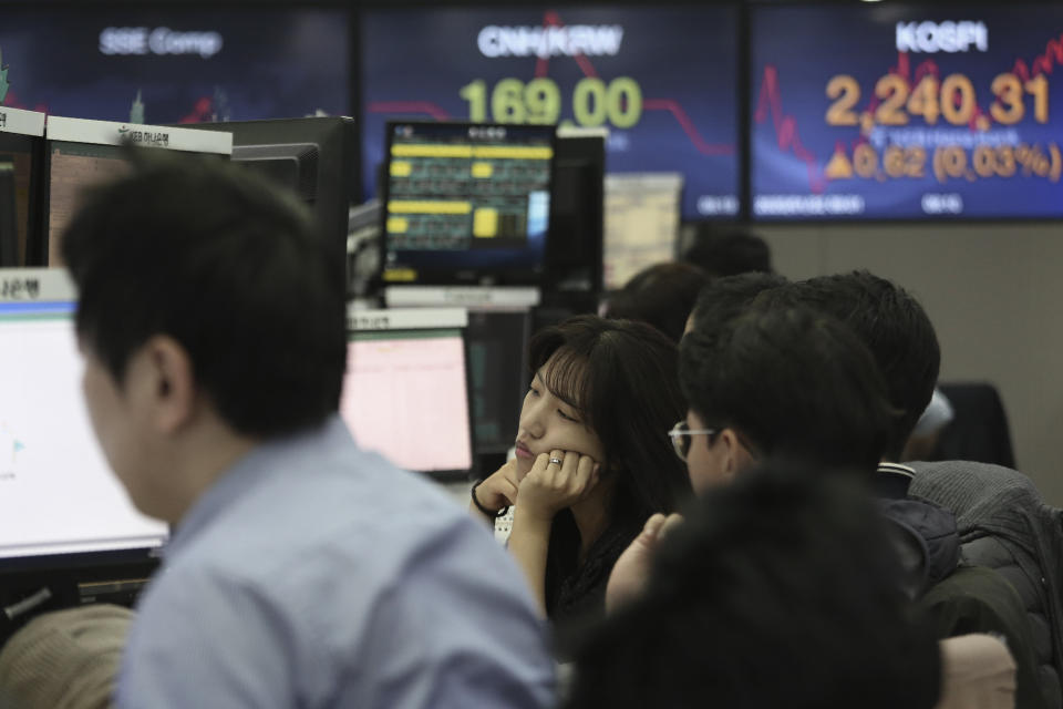 A currency trader watches monitors at the foreign exchange dealing room of the KEB Hana Bank headquarters in Seoul, South Korea, Wednesday, Jan. 22, 2020. Shares advanced in early Asian trading after a slide in U.S. stocks Tuesday as a virus outbreak in China rattled global markets. (AP Photo/Ahn Young-joon)