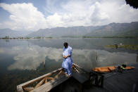 A Kashmiri Muslim man offers prayer on the banks of Dal Lake on the second day of Ramadan during lockdown to prevent the spread of the new coronavirus in Srinagar, Indian controlled Kashmir, April 26, 2020. Kashmiri shrines that are usually packed with devotees during the holy month of Ramadan wore a deserted look Sunday as authorities closed the shrine for the safety of the public. (AP Photo/Mukhtar Khan)