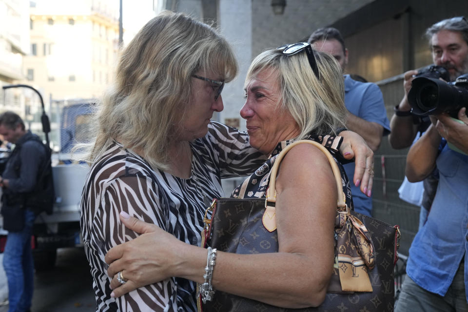 Paola Vicini, right, and Maria Grazia Lonigro, mothers of Mirko Vicini and Luigi Matti Altadonna, two of the 43 victims, greet each other outside the Genoa's Palace of Justice on opening of the first hearing of the trial for the Morandi bridge collapse,Thursday, July 7, 2022. Forty-three people were killed when a large stretch of the Morandi Bridge broke off, August 14, 2018, on the eve of one of Italy's biggest vacation holidays. (AP Photo/Antonio Calanni)