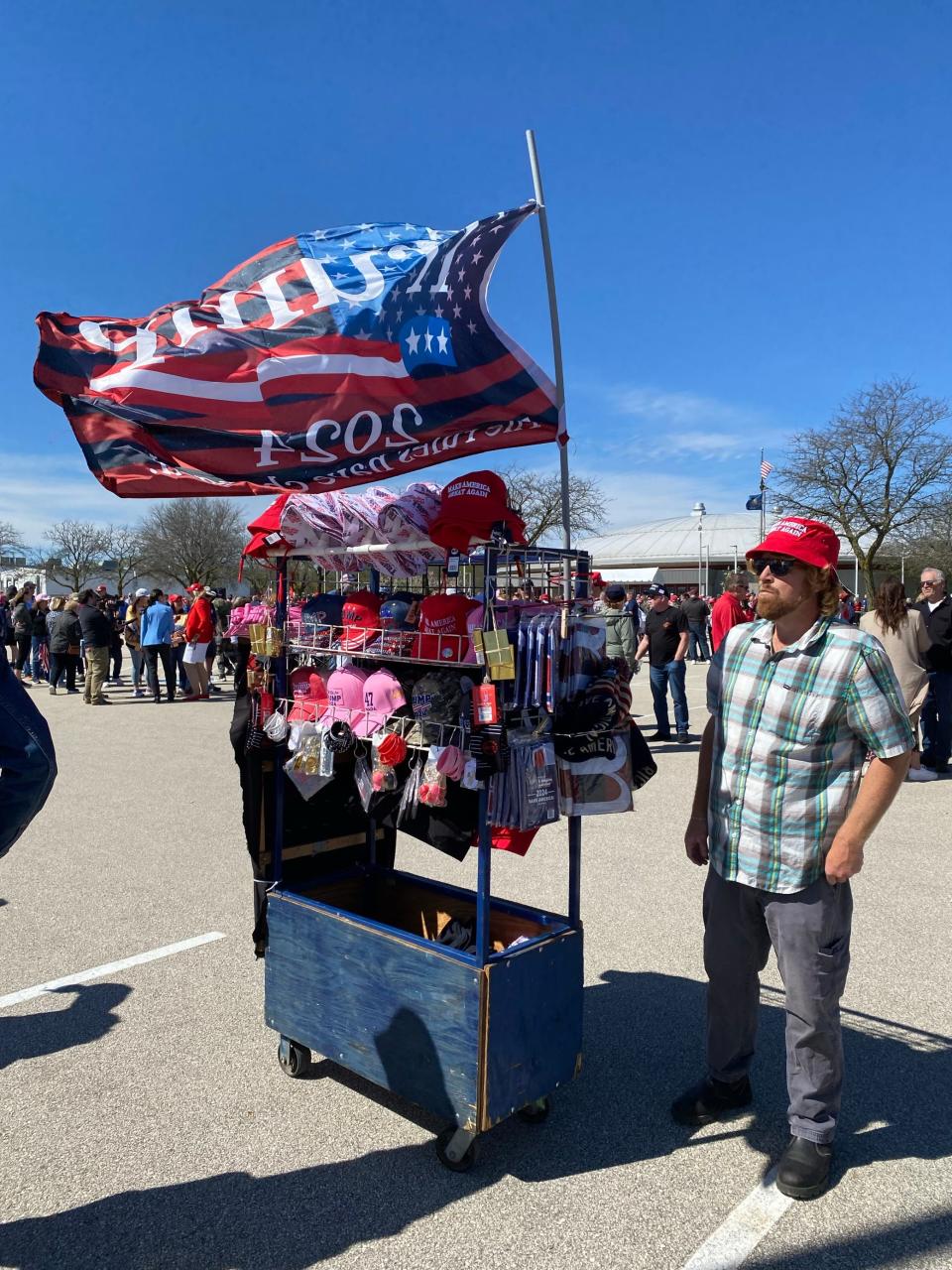 Steven Reid from Tennessee sells Trump merchandise outside a rally in Waukesha.