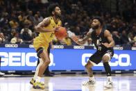 West Virginia guard Taz Sherman (12) is defended by Eastern Kentucky guard Jomaru Brown (11) during the first half of an NCAA college basketball game in Morgantown, W.Va., Friday, Nov. 26, 2021. (AP Photo/Kathleen Batten)