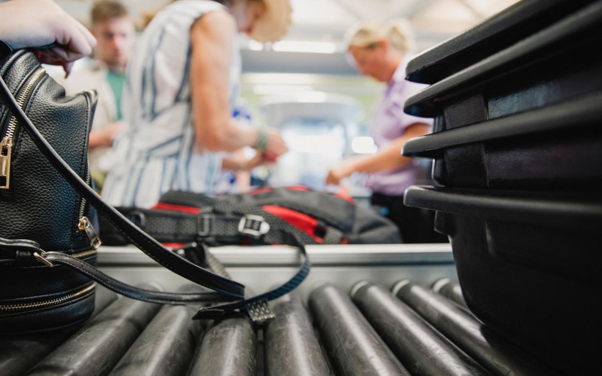 Close up shot of luggage being inspected by security at the airport.