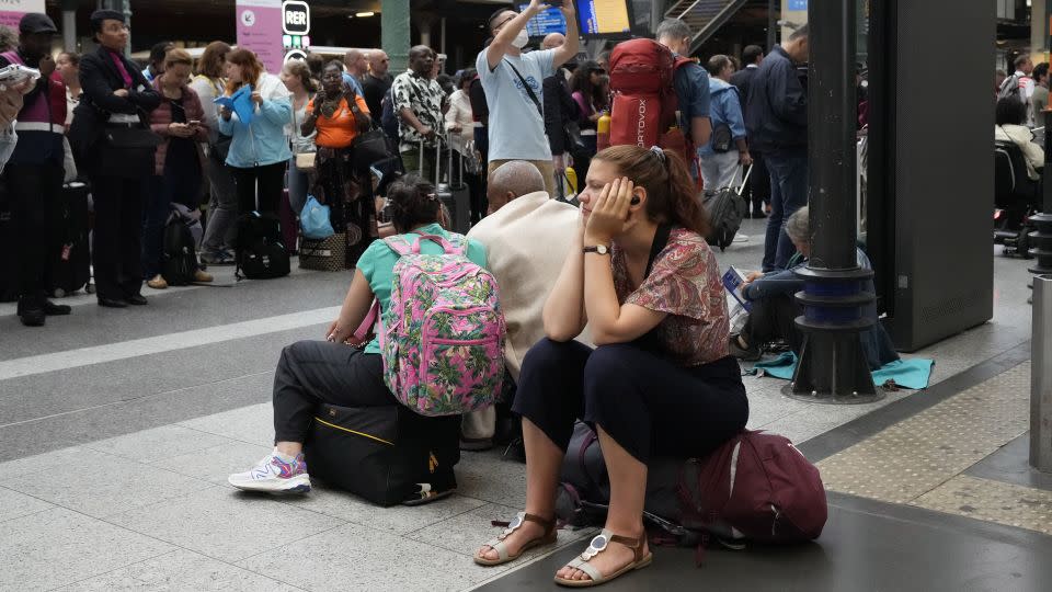 A traveler waits inside the Gare du Nord train station in Paris on July 26. - Mark Baker/AP