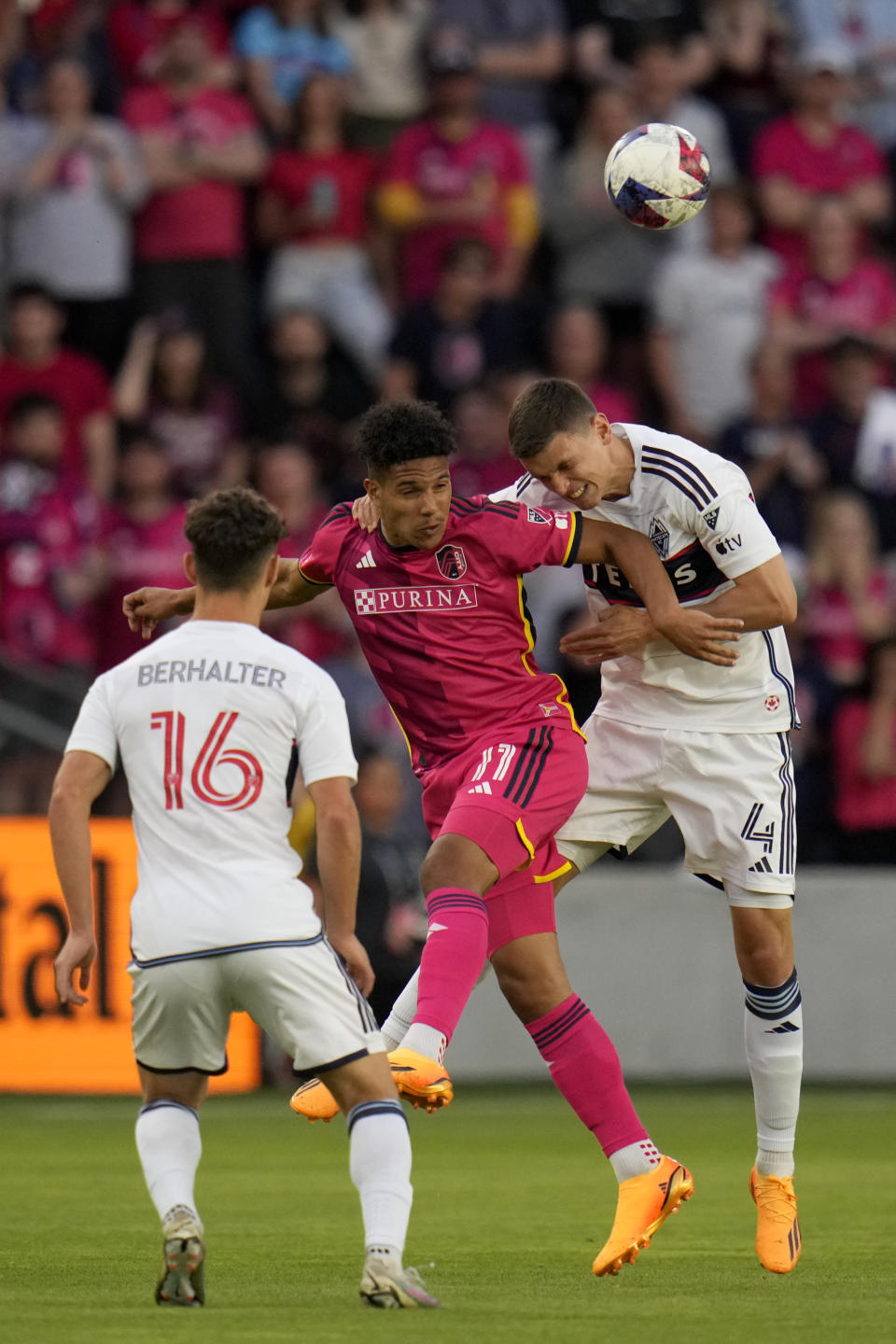 St. Louis City's Nicholas Gioacchini (11) and Vancouver Whitecaps' Ranko Veselinovic (4) reach for the ball as Whitecaps' Sebastian Berhalter (16) watches during the first half of an MLS soccer match Saturday, May 27, 2023, in St. Louis. (AP Photo/Jeff Roberson)