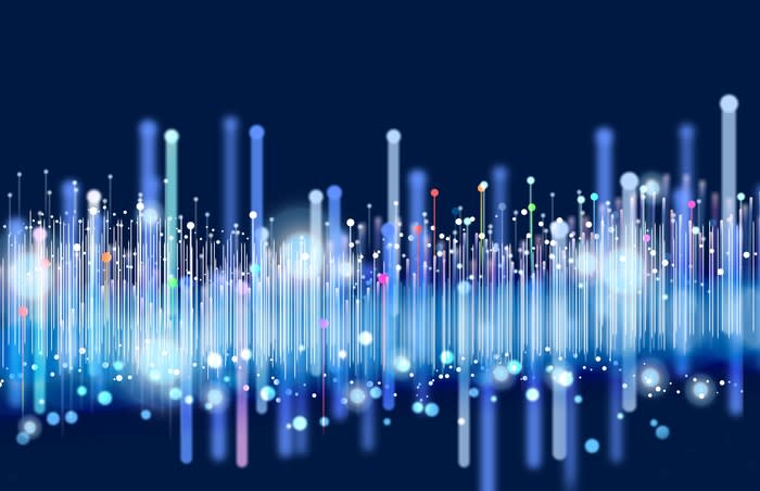 Colorful illuminated bright vertical lines on a black background symbolize big data transfer over a network.