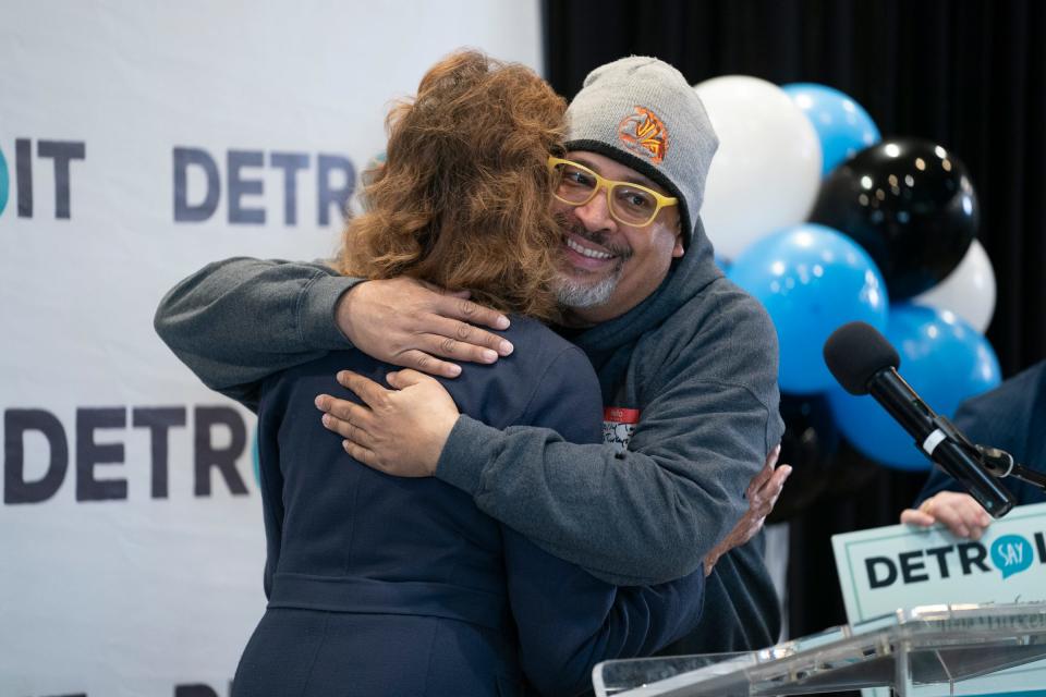 Carmen Harlan, left, a board member for SAY Detroit, gets a hug from Jive Turkeys Detroit Chief Visionary Officer Harry Todd as she presents his organization with a $5,000 check raised by SAY Detroit's Radiothon, which raises money to hand out supporting funds to philanthropic organizations around Detroit on Thursday, April 4, 2024 at the Start Up Nation event space in Birmingham.