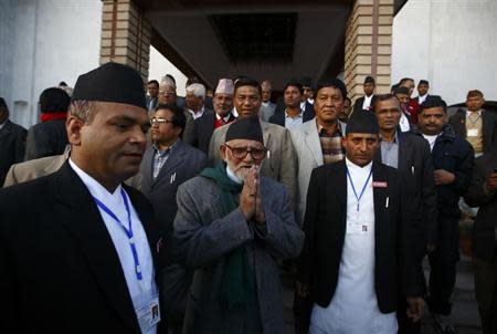 Sushil Koirala (C), Chairman and parliamentary party leader for the Nepali Congress Party, greets supporters, after filing his nomination for the post of prime minister for the election to be held on Monday, at the Parliament Secretariat, in Kathmandu February 9, 2014. REUTERS/Navesh Chitrakar