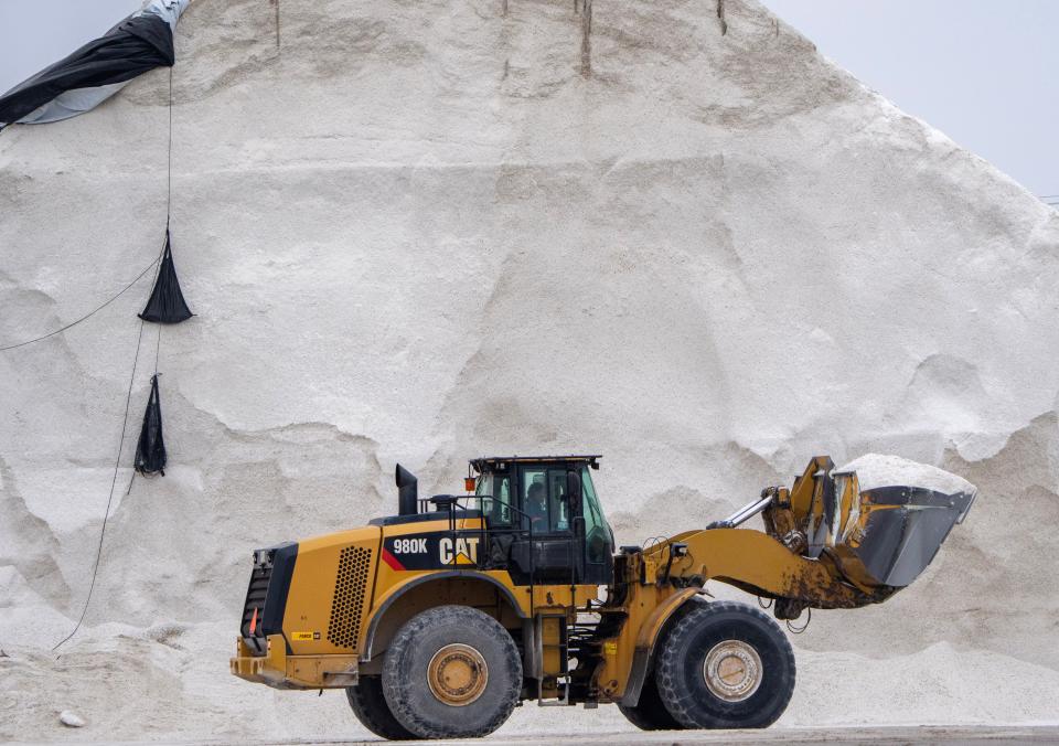 A loader carries salt to a waiting truck on Jones Island in Milwaukee. Salinity is on the rise in waters across Wisconsin.