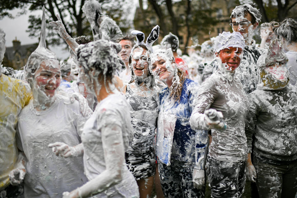 <p>Students from St Andrews University indulge in a tradition of covering themselves with foam to honor the “academic family” on Lower College Lawn on Oct. 23, 2017, in St Andrews, Scotland. (Photo: Jeff J Mitchell/Getty Images) </p>