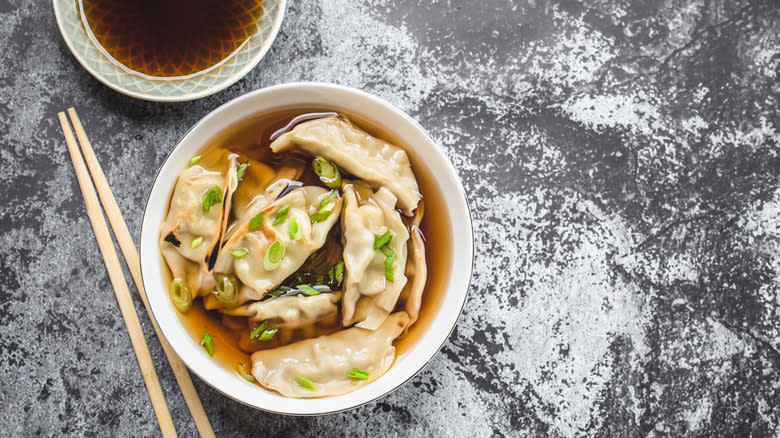 Dumplings and scallions in broth