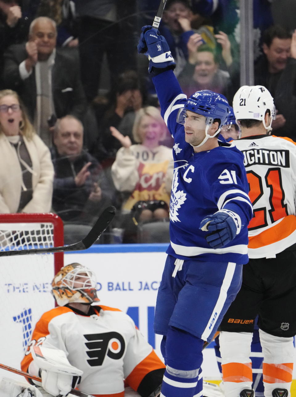 Toronto Maple Leafs' John Tavares (91) celebrates his third goal of the game against Philadelphia Flyers goaltender Felix Sandstrom (32) during the third period of an NHL hockey game in Toronto on Wednesday, Nov. 2, 2022. (Frank Gunn/The Canadian Press via AP)