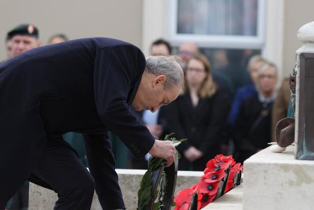 Taoiseach Michael Martin laying a wreath during the service 