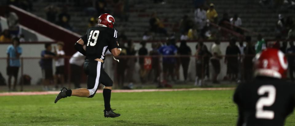 Manual's Cameron Jessee picks up the ball and returns it for a touchdown against Central. Aug. 18, 2023