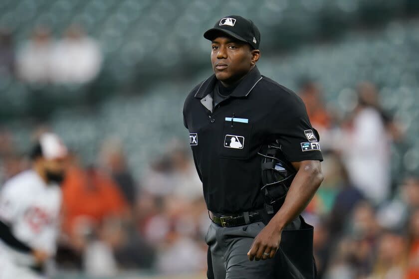 Home plate umpire Malachi Moore looks on during the first inning of a baseball game.