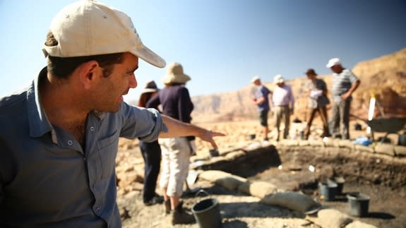 In this photo from 2013, archaeologist Erez Ben-Yosef points to a trench at Slaves' Hill, a copper smelting camp in Timna Valley.